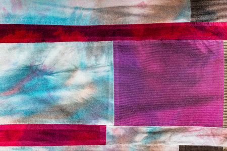 textile background - hand-crafted patchwork cloth from velvet and batik pieces