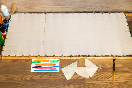 blank fabric attached to wooden frame on table at home prepared for batik paintingの写真素材