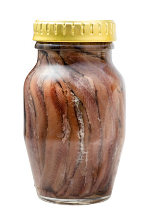 glass jar of canned anchovy fillets isolated on white backgroundの写真素材