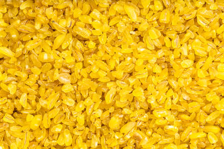 food background - uncooked bulgur wheat groatsの写真素材