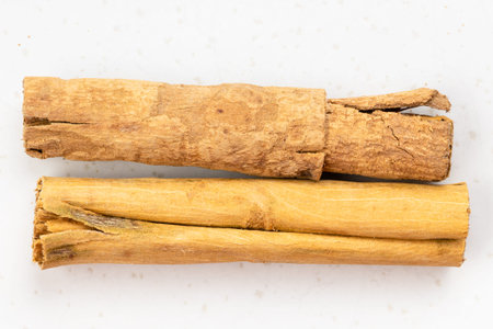 top view of two sticks of continental ceylon cinnamon close up on gray ceramic plate
