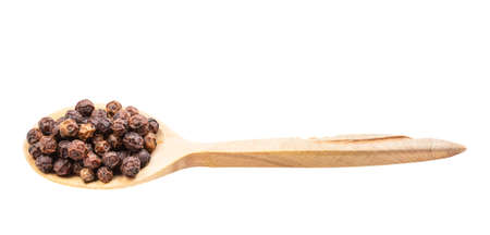 red kampot pepper in wooden spoon isolated on white backgrounsの写真素材