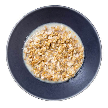 top view of cooked porridge from wholegrain oat in gray bowl isolated on whitte backgroundの写真素材