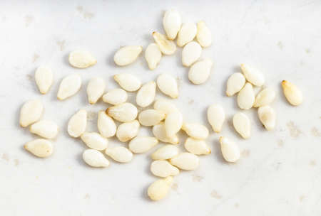 several white sesame seeds close up on gray ceramic plateの写真素材