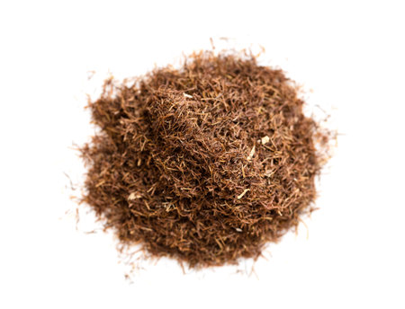 top view of pile of grinded dried corn silk close up on white plate