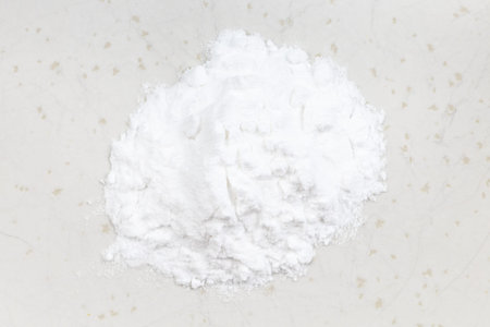 top view of pile of potato starch close up on gray ceramic plate