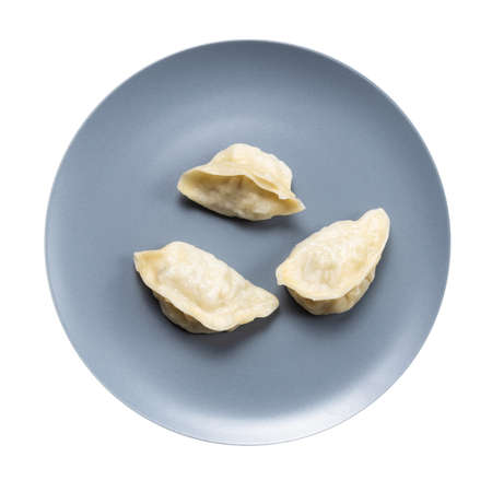 top view of few boiled dumplings on gray plate isolated on white backgroundの写真素材