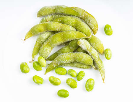 top view of frozen pods and seeds of Edamame (unripe soybeans) on gray ceramic plateの写真素材