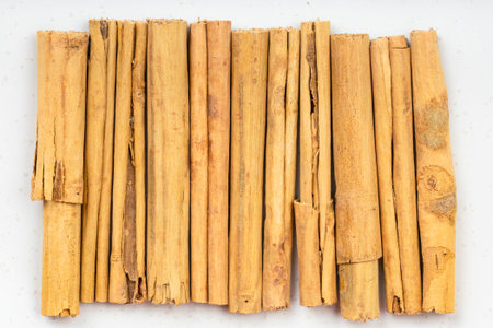 top view of several sticks of alba premium ceylon cinnamon close up on gray ceramic plate