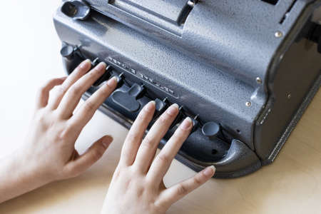 Moscow, Russia - June 5, 2021: fingers touch of Perkins Brailler braille typewriter. The first Perkins Brailler was produced in 1951 by David Abraham, teacher at the Perkins School for the Blindのeditorial素材