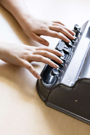 Moscow, Russia - June 5, 2021: hands touch of Perkins Brailler braille typewriter. The first Perkins Brailler was produced in 1951 by David Abraham, teacher at the Perkins School for the Blindのeditorial素材