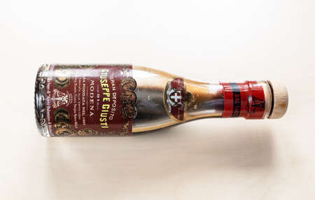 MOSCOW, RUSSIA - JUNE 10, 2021: lying used glass bottle of aged Giuseppe Giusti Aceto Balsamico di Modena on pale board. Giusti family is Italy's oldest Balsamic Vinegar producer since 1605のeditorial素材
