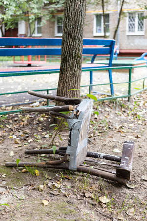 old broken wooden chair in courtyard of city houseの写真素材