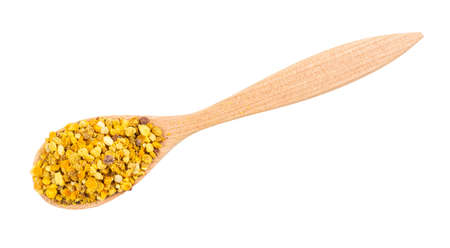 top view of wooden spoon with portion of natural bee pollen isolated on white backgroundの写真素材
