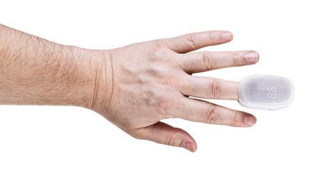 pulse oximeter on male finger tip isolated on white background