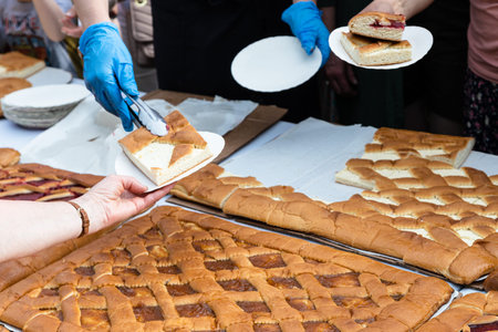 placing portion of open sweet cheese pie in paper plate