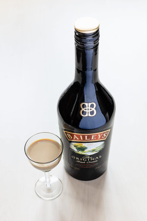 Moscow, Russia - August 2, 2022: top view of wineglass with Baileys Irish Cream liqueur and bottle...