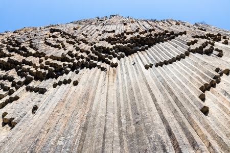symphony of the stones - bottom view of surface natural basalt columns in Garni gorge in Armenia on sunny autumn dayの写真素材