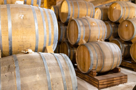 Yerevan, Armenia - October 2, 2023: many wooden barrels with brandy in cellar of NOY factory in...