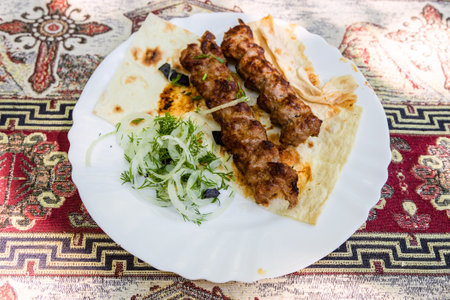 portion of kebabs on plate in Armenian village outdoor restaurantの写真素材
