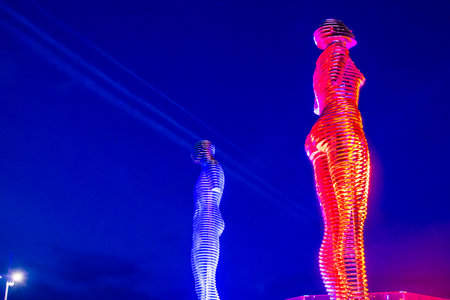 Batumi, Georgia - September 16, 2023: illuminated Statue of Man and Woman (Ali and Nino) and blue sky in Batumi city in autumn night. Statue was made by Georgian artist Tamara Kvesitadzeのeditorial素材