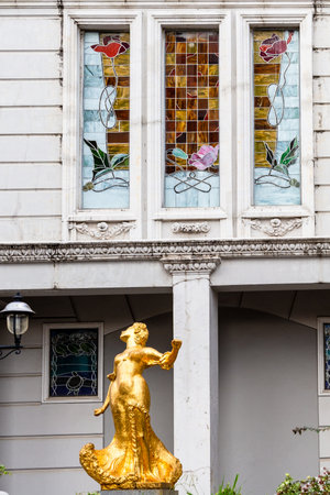 Batumi, Georgia - September 16, 2023: golden statue and stained glass windows of oleg galogre hotel on Piazza Square in Batumi city.のeditorial素材
