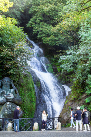 Sarpi, Georgia - September 18, 2023: tourists near St Andrew the First-Called sculpture and Waterfall in Sarpi village, Adjara. Monument is dedicated to entry of St Andrew the First-Called into Georgiのeditorial素材
