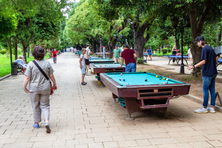 Batumi, Georgia - September 16, 2023: billiard tables on alley of green seaside boulevard in Batumi...