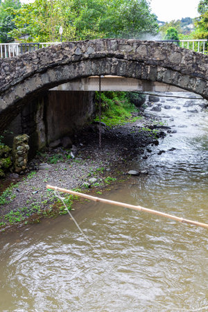 travel to Georgia - fishing in river Makho near ancient arch bridge of Queen Tamar in Maho village,...