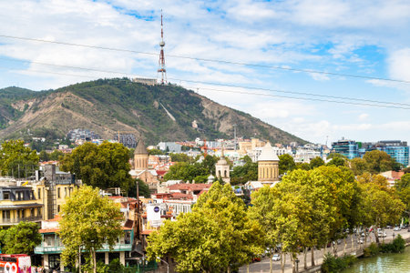 Tbilisi, Georgia - September 26, 2023: view of Georgia Tbilisi TV Broadcasting Tower on Mtatsminda hill over old town on waterfront of Kura River in Tbilisi city from Metekhi viewpoint on autumn dayのeditorial素材