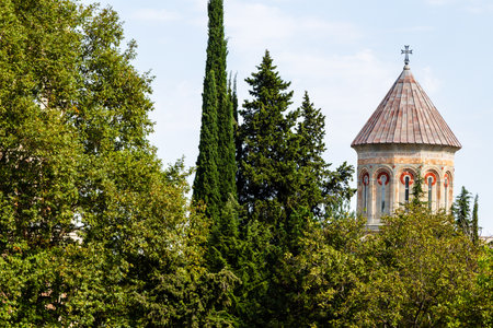Bodbe, Georgia - September 24, 2023: green trees and dome of cathedral in Bodbe Monastery of St Nino in Kakheti region of Georgia on sunny autumn dayのeditorial素材