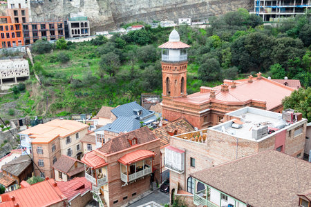 Tbilisi, Georgia - September 23, 2023: above view of residential houses and minaret of Jumah mosque on Botanical street in Tbilisi city from Sololaki hill on cloudy autumn dayのeditorial素材