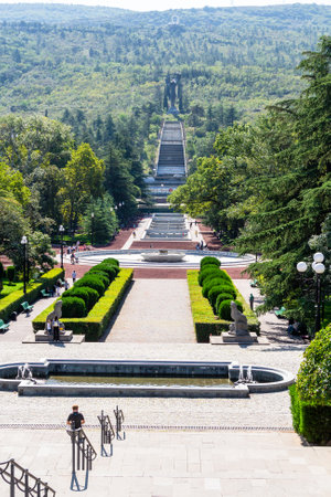Tbilisi, Georgia - September 27,2023: view of alley in Vake Park with Statue of Victory from staircase in Vake district of Tbilisi city on sunny autumn dayのeditorial素材