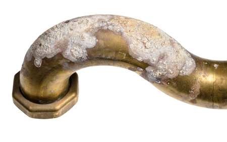 corrosion on brass elbow of bath tub close up isolated on white background
