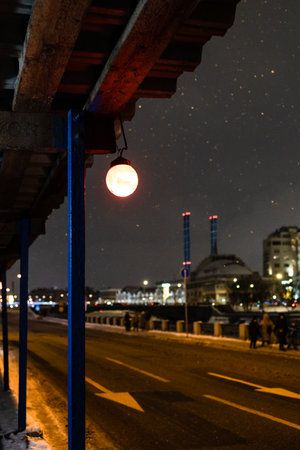 electric lamp of pedestrian crossing being repaired on Kadashevskaya embankment in Moscow city on winter nightの写真素材