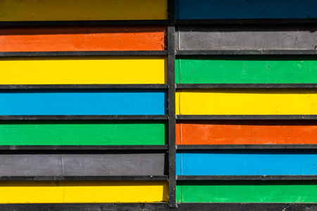 multicolored wooden planks on wall of house in Dilijan city, Armenia on sunny summer dayの写真素材