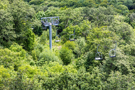 cableway lifts on mountain slope in Tsaghkadzor town, Armenia on summer cloudy day