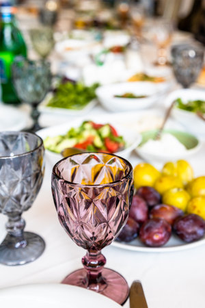 empty faceted wine glass on served table before lunch in Armenian rural tourist restaurant in Sevan, Armeniaの写真素材