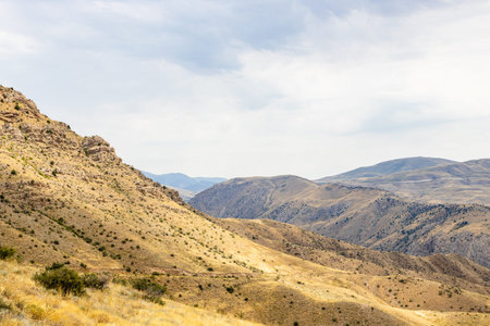 view of mountains on road between Ararat and Vayots Dzor Provinces, Armenia on cloudy summer day
