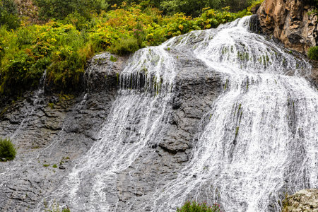 view of water stream of Jermuk Waterfall in Arpa river gorge on rainy summer dayの写真素材