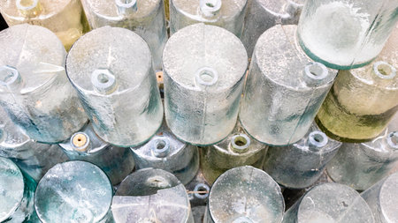 glass cylindrical vessels blanks for bottle making in glass blowing shop warehouseの写真素材