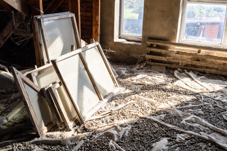 removed old glass and wooden window frames in attic of village house