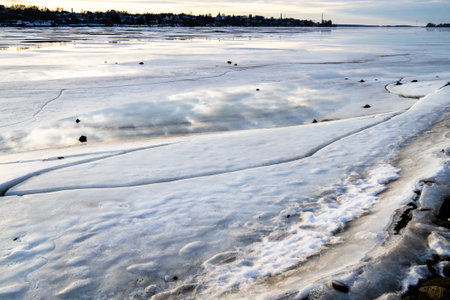 frozen river in Kostroma city in winter evening twilightの写真素材