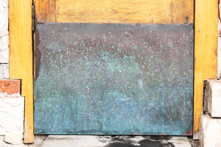 green and red brown surface of old copper plate closes hole in outdoor door close upの写真素材