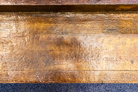 varnished wooden floorboard indoors house close up lit by electric lightの写真素材