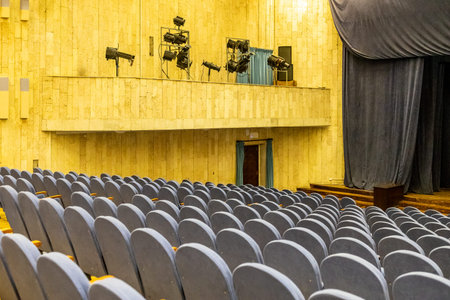 rows of gray soft seats in auditorium of theater