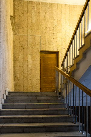 stairs with railings between floors in entrance of buildingの写真素材