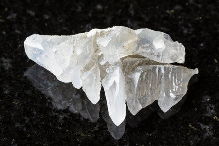 sample of raw salammoniac mineral on black granite background close up from Tajikistan