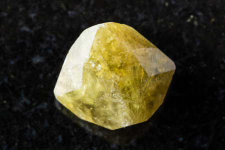sample of raw green grossular garnet crystal on black background close up from Vilyuy, Yakutia,...