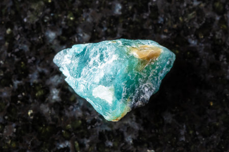 sample of rough grandidierite crystal on black granite background close up from Madagascarの写真素材